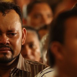 A brother mourns the death of a repatriated loved one (photo by Marc Silver)